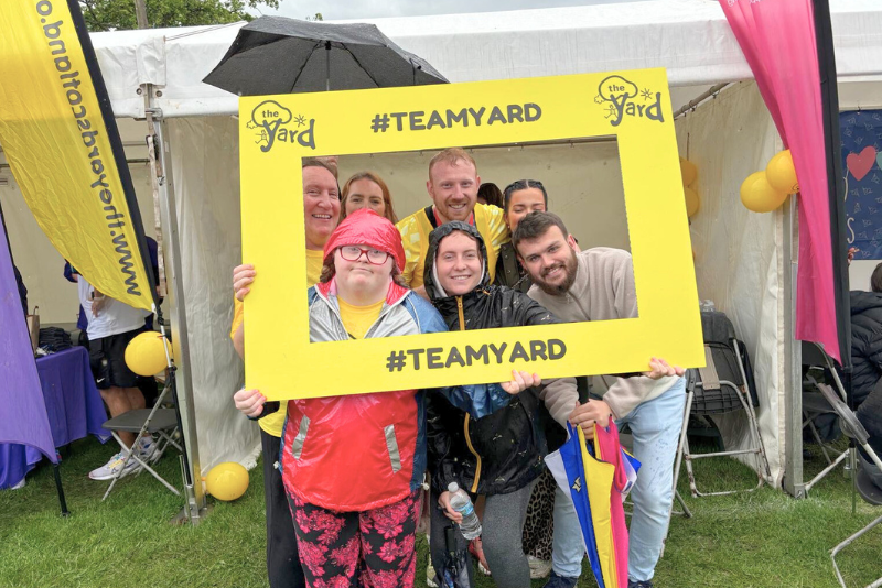 Group of fundraisers taking a picture with a Yard selfie frame